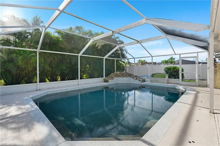 View of swimming pool with a patio and glass enclosure