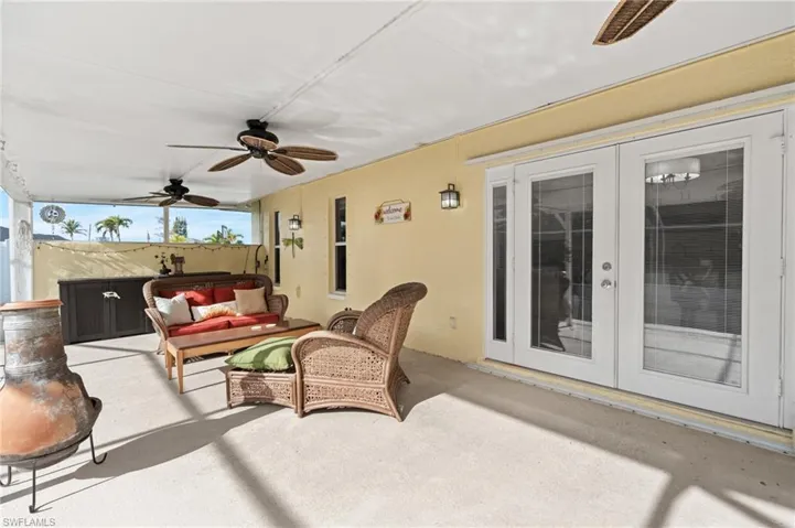 View of patio featuring outdoor lounge area, ceiling fan, and french doors
