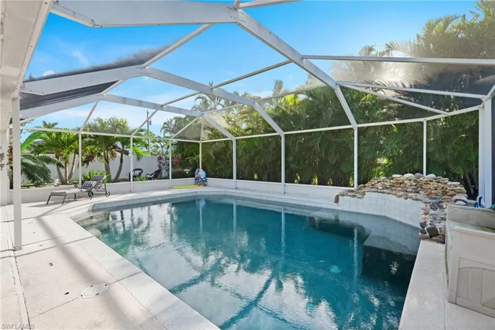 View of pool with a lanai and a patio area