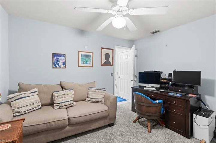 Office space featuring light colored carpet and ceiling fan