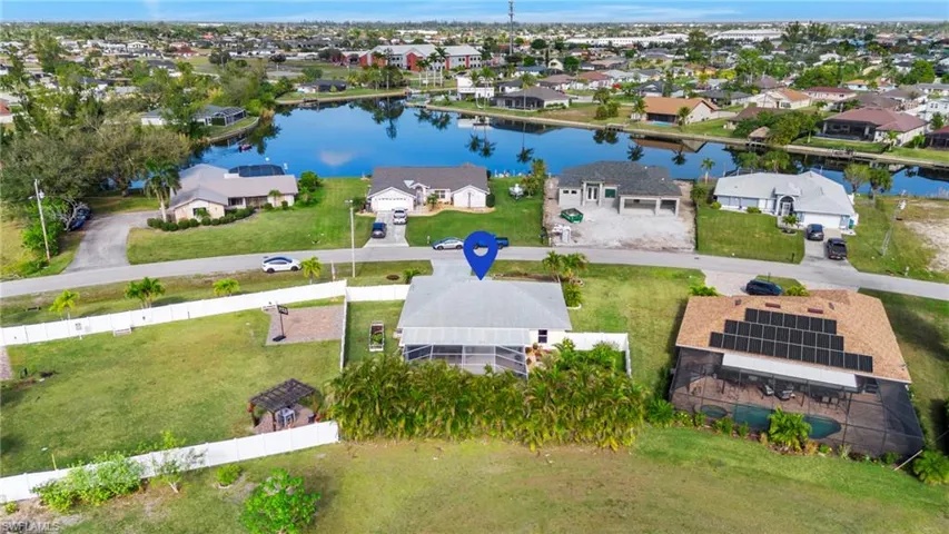 Birds eye view of property with a water view