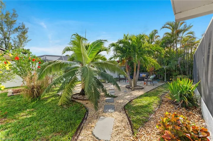 View of yard featuring a patio and glass enclosure