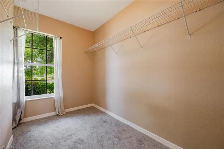 Walk in closet featuring carpet flooring