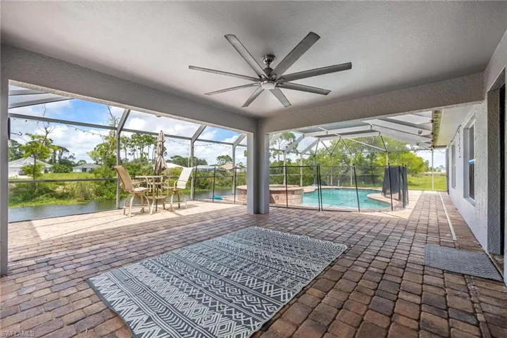 Unfurnished sunroom featuring ceiling fan