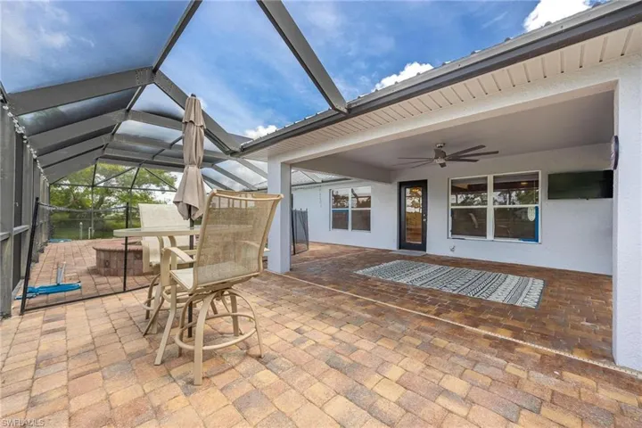 Unfurnished sunroom featuring ceiling fan
