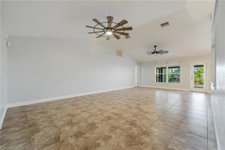 Unfurnished living room featuring ceiling fan and light tile patterned floors