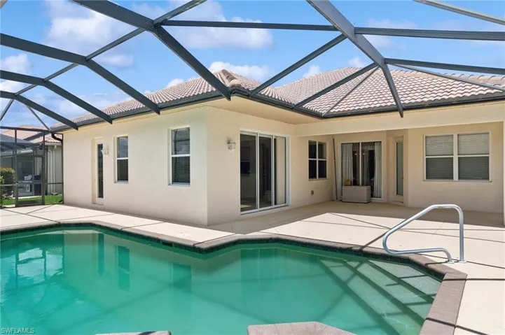 Swimming pool featuring a patio and glass enclosure