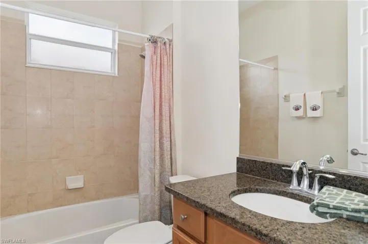 Bathroom with vanity and shower / bath combo