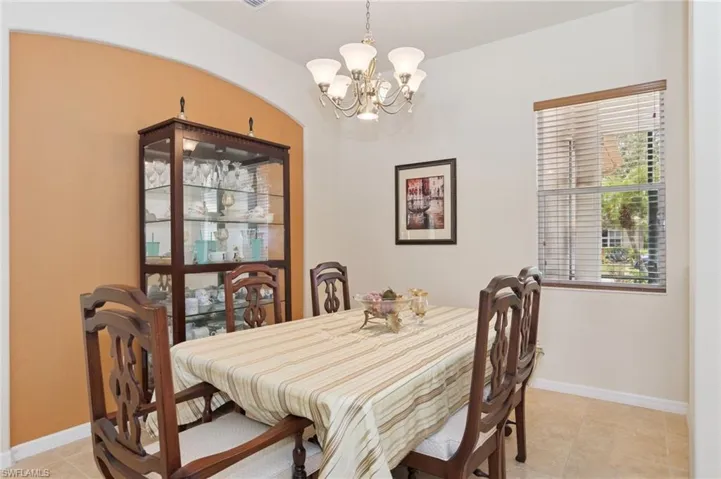Dining area with a chandelier and light tile patterned flooring