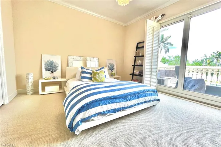 Bedroom featuring ornamental molding and carpet