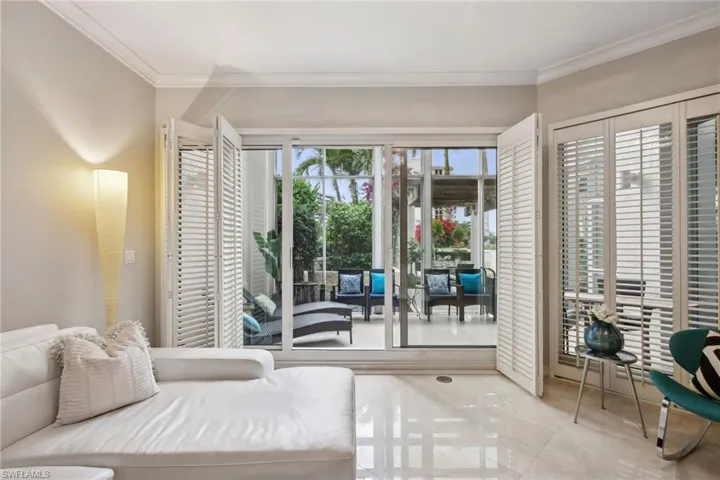 Bedroom with access to exterior and crown molding