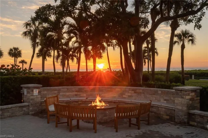 Patio terrace at dusk featuring an outdoor fire pit