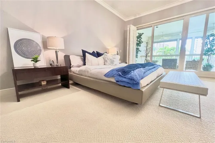 Bedroom featuring ornamental molding, baseboards, access to outside, and light carpet