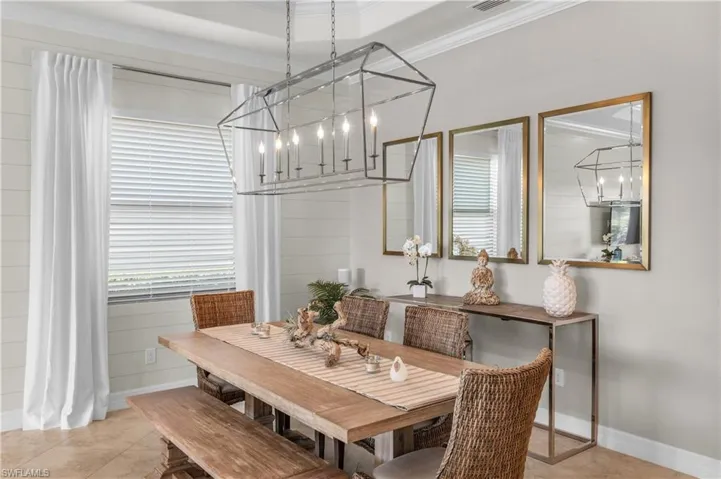 The Dining area features crown molding, raised tray ceiling and premium lighting fixtures