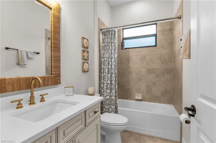 Third bath between guest room and den with Quartz, new fixtures, and shower/tub combination.