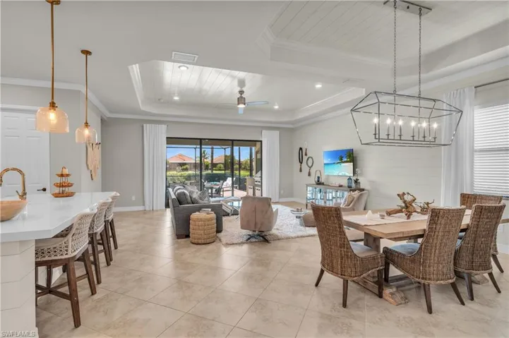Open Floor Plan with shiplap on coffered ceilings, center island, and living area walls.