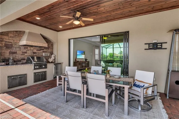 Alfresco dining featuring tongue n groove wood ceiling