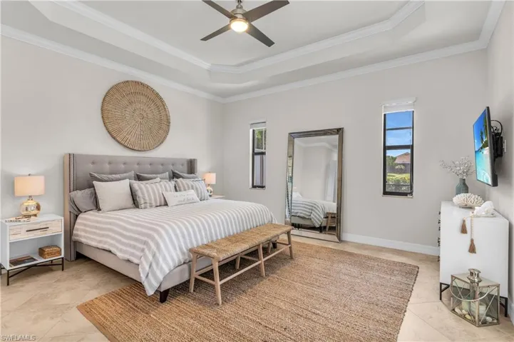 Generous Primary Bedroom with tray ceiling and crown molding