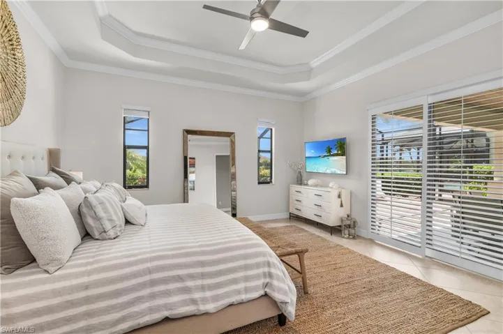 Primary Bedroom with double  tray ceiling, patio access and natural lighting