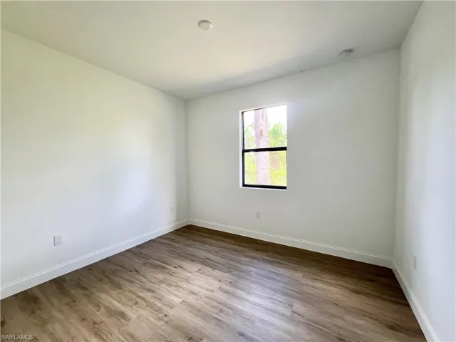 Spare room featuring hardwood / wood-style flooring