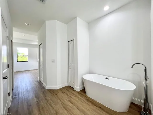 Bathroom featuring hardwood / wood-style floors and a tub