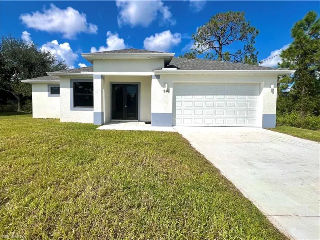 View of front of property featuring a garage and a front yard