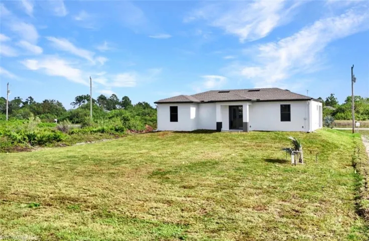 Rear view of property featuring a yard