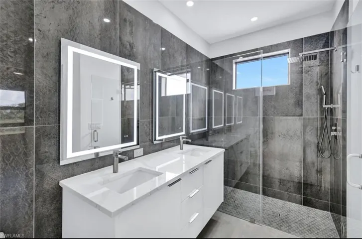 Bathroom with an enclosed shower and vanity