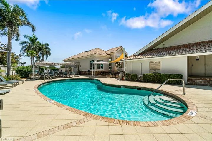 Community pool with a patio