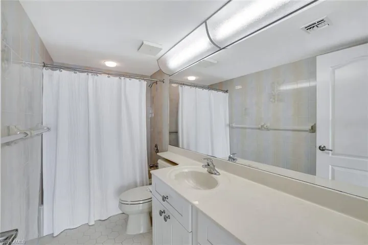 Bathroom featuring tile patterned flooring, vanity, and toilet