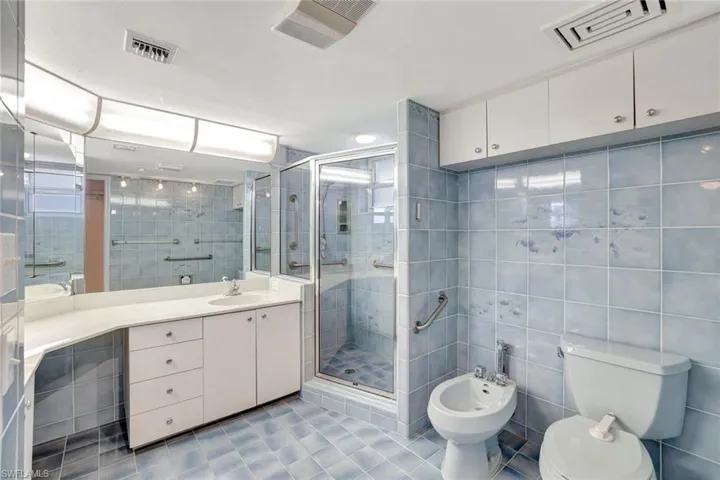 Bathroom complete with a bidet, shower and double vanity
