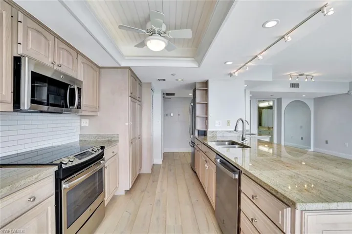 Kitchen featuring light hardwood / wood-style flooring, light brown cabinets, sink, and stainless steel appliances