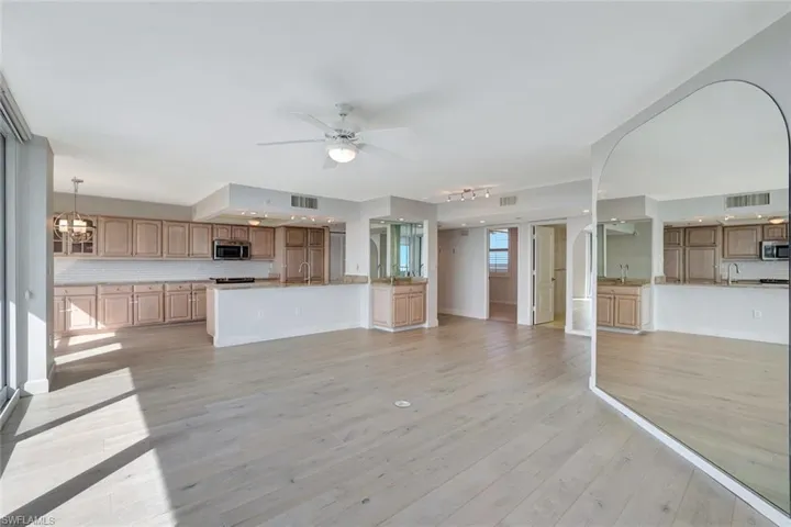 Kitchen featuring ceiling fan with chandelier and light hardwood / wood-flooring