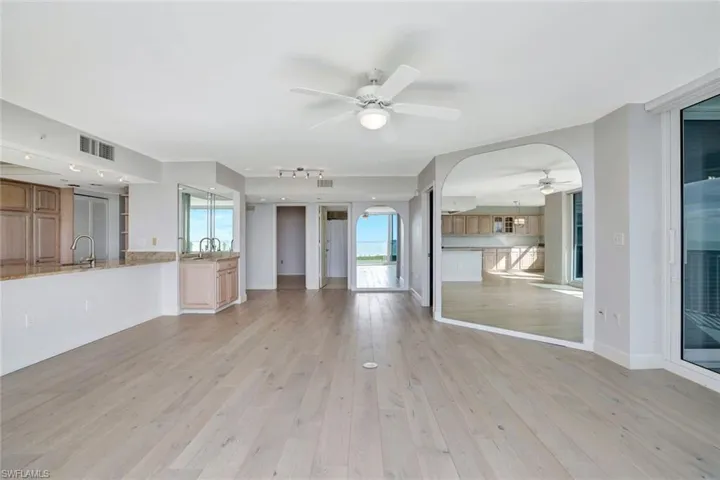 Living room featuring light hardwood flooring and wet bar