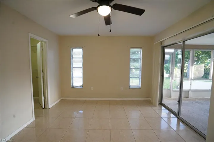Spare room with light tile patterned floors and a ceiling fan