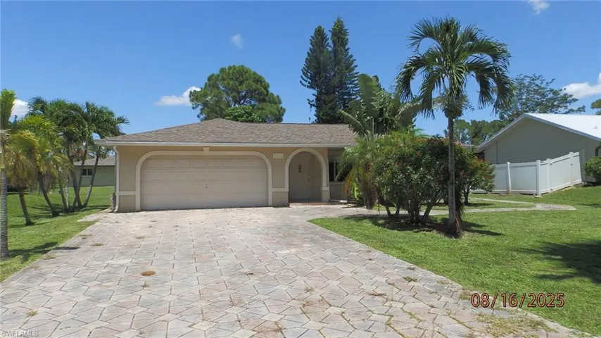 Ranch-style home featuring stucco siding, decorative driveway, an attached garage, and roof with shingles