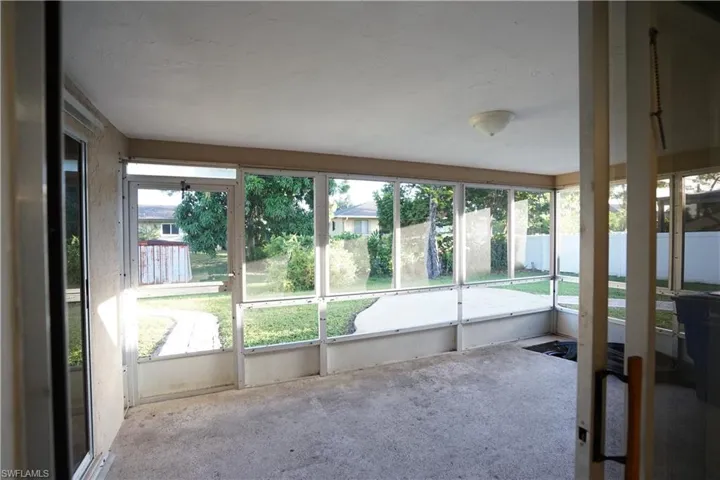 Unfurnished sunroom featuring plenty of natural light