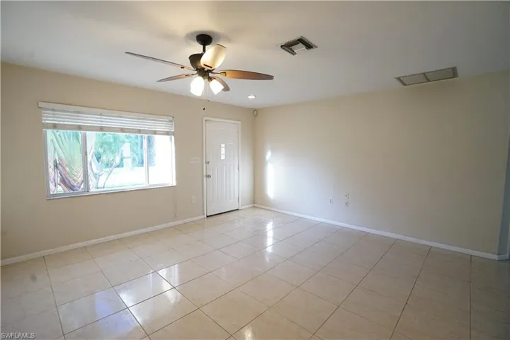Spare room featuring light tile patterned floors and ceiling fan