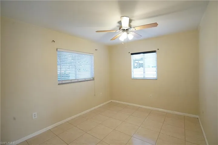 Unfurnished room with light tile patterned flooring and ceiling fan