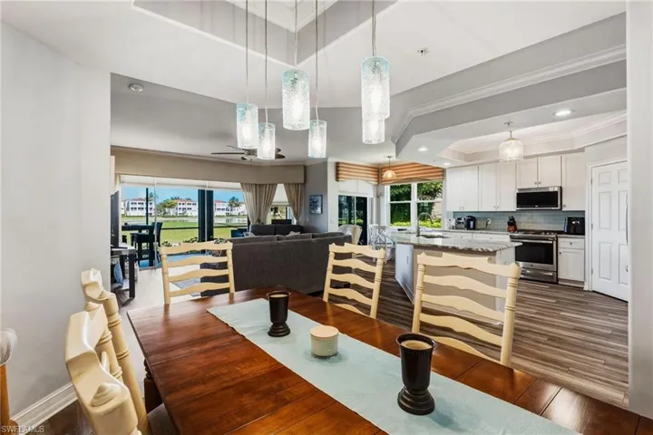 The cozy formal dining area features a tray ceiling, custom lighting, and, of course, those fabulous views.