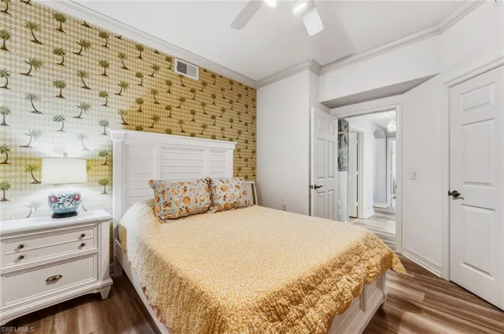 The second bedroom is generously sized and thoughtfully positioned within a split floor plan, offering an ideal retreat for guests while ensuring optimal privacy.