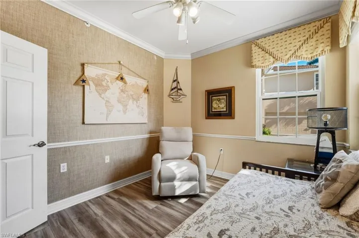 The third bedroom features elegant crown molding and classic chair railing, adding timeless detail and charm to the space.