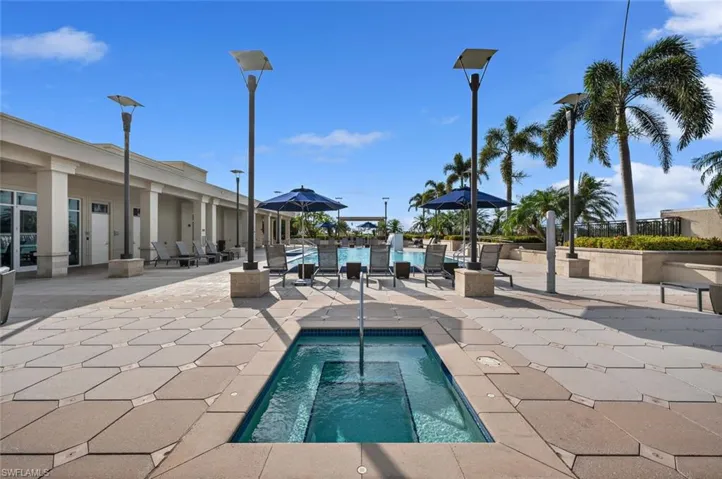 View of swimming pool with an in ground hot tub and a patio area