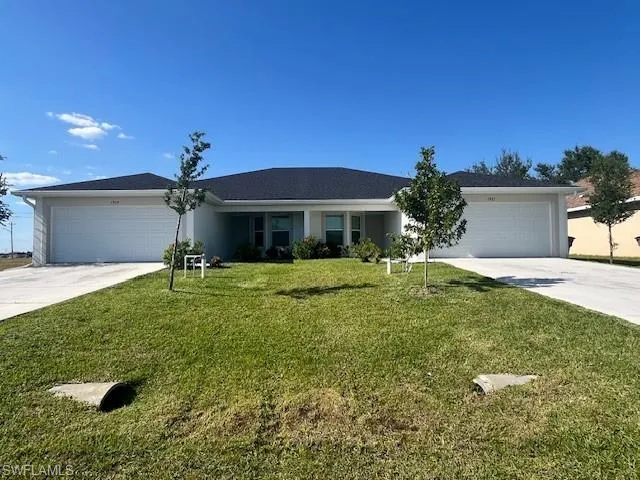BEAUTIFUL CURB APPEAL.  SEPARATE DRIVEWAYS, 2 CAR GARAGE ON EACH SIDE, GUTTERS ALONG THE FRONT.