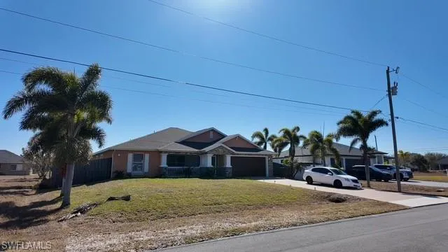 View of front of house with concrete driveway and a garage