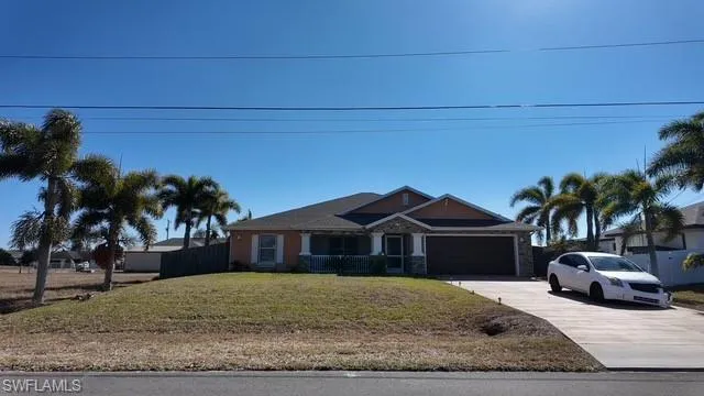 View of front facade with driveway and an attached garage