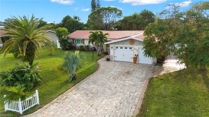 Ranch-style house with a front lawn and a garage