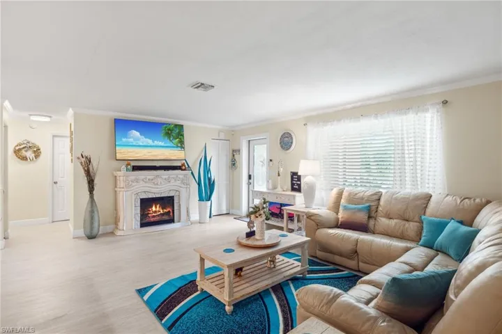 Living room featuring light hardwood / wood-style flooring and ornamental molding