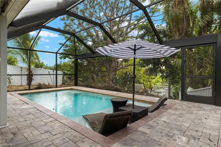 View of pool with a patio and a lanai