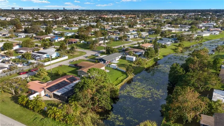 Birds eye view of property with a water view